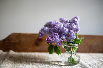 Lilac flowers in a small glass vase