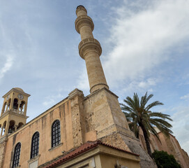 Fototapeta premium Crete island, Greece. Agios Nikolaos at Chania Old Town, Hunkar Mosque, bell tower and minaret