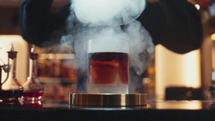 Cropped bartender serving mist smoky classical mixing whiskey cocktail fantastic presentation, recommending special welcome tasty creative advertisement drink at beverage counter bar luxury. Vinosity.