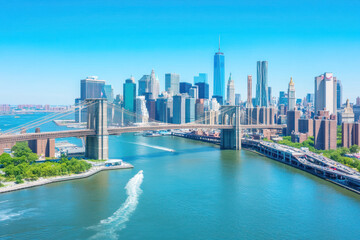 Fototapeta premium Aerial view of new york city skyline with the iconic brooklyn bridge and skyscrapers under a clear blue sky