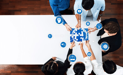 A diverse team engages in collaborative brainstorming, assembling puzzle pieces symbolizing strategies in artificial intelligence, showcasing innovation and teamwork in a modern office. Amity
