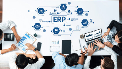 A diverse group of professionals collaborates in a modern office setting, analyzing data and discussing strategies for effective enterprise resource planning and business growth. Amity