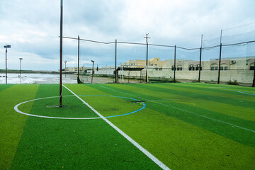 outdoors green playground for mini football in an Omani village