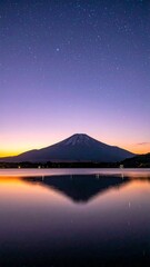 Tranquil lake landscape at sunrise or sunset with reflections of mountains and sky, sunrise over the lake, sunset over lake