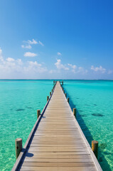 Obraz premium Tranquil Pier Over Turquoise Waters - Serene boardwalk extending over vibrant turquoise sea under a clear blue sky, symbolizing peace, journey, escape, hope, and tranquility