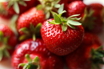 fresh strawberries with green leaves, close up photo