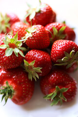 fresh strawberries with green leaves, close up photo