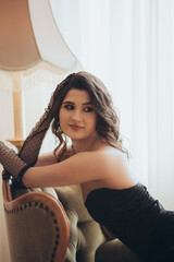 Confident Woman in Black Dress Looking Over Shoulder