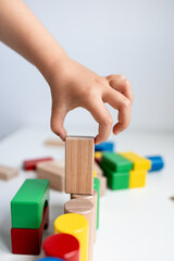 Child playing with colorful wooden blocks
