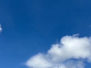 Dynamic composition of pure white clouds, textured against a bright blue sky, unique clouds, weather, bright, suitable for atmospheric backgrounds, or as an eye-catching design element.