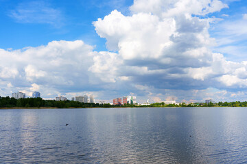 Fototapeta premium Scenic View of Kyiv Skyline Reflected in Calm Waters Under Clouds