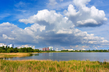 Scenic View Of Kyiv Skyline Reflected In Calm Lake Under Clouds