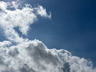 Dynamic composition of pure white clouds, textured against a bright blue sky, unique clouds,...
