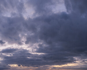 Panorama of a moody and wild cloudscape during blue hour after sunset