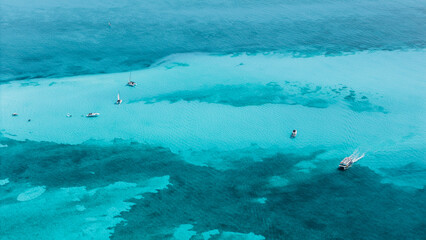 Aerial view of boats and yachts sailing in the waters off the beaches of the Riviera Maya. Beautiful blue waters and a sunny day. Copy space.