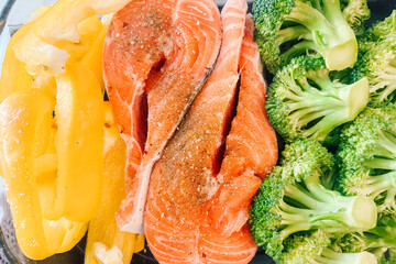 Grilled salmon with colorful bell peppers and fresh broccoli served on a plate