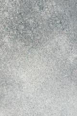 Gray textured surface with subtle variations in tone and pattern observed in natural light