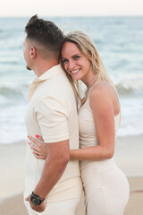 Fototapeta premium Young happy traditional couple in love in summer at sea on the beach. Love. Family.