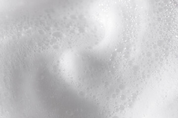 Foamy white skincare texture on a clean surface