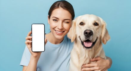 Smiling woman with golden retriever showcasing smartphone on blue background