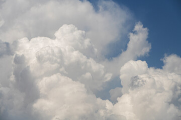 Blue sky with fluffy white close up clouds.. Clouds background.