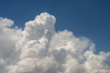 Blue sky with fluffy white close up clouds.. Clouds background.