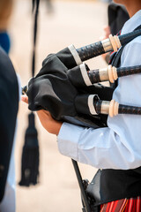 A close-up of a person holding bagpipes
