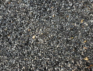 texture of grey granite gravel stones on ground.
Pebbles background 

