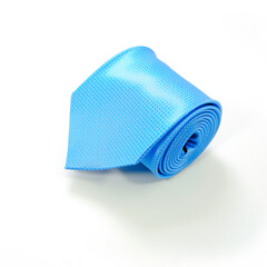 A blue tie rolled on white background closeup shot 