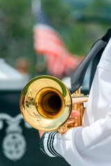 A Navy band member holding a trumpet 