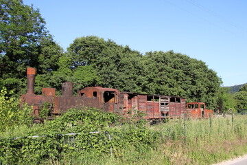 old rusty locomotive abandoned in a field