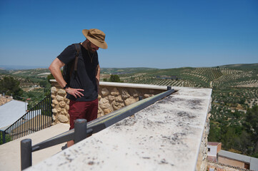 Traveler Exploring Scenic Mountain Viewpoints Surrounded by Lush Olive Groves