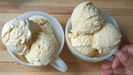 Rich, velvety mango ice cream scooped into white cups—tropical, fruity, and perfect for summer indulgence.