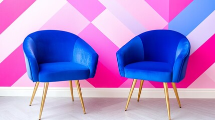 Two blue chairs against vibrant pink geometric wall design