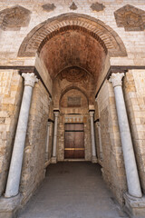 Fototapeta premium Exterior view of the large arched entrance to the Mosque of al-Zahir Baybars in Cairo, Egypt. Architectural details such as the stonework, arches, and columns are visible