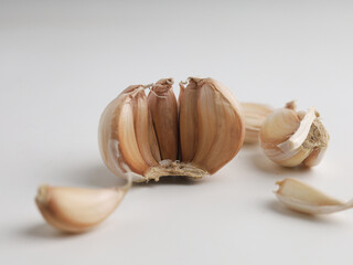 Garlic cloves on white background