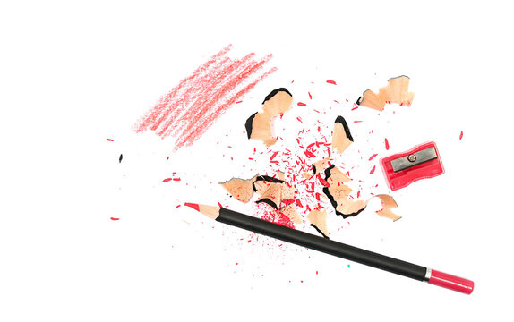 wooden crayons with plastic red sharpener and shavings isolated on white, top view