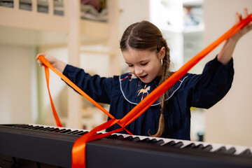 Girl Unwrapping Gifted Keyboard with Excitement