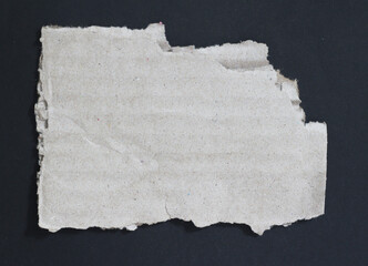 Torn rip paper texture on black background