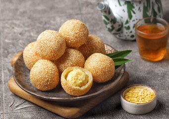 Onde-onde or Kuih Bom or Banh Cam or Jian Dui is a traditional snack made from sticky rice flour with a skin coated with sesame seeds and filled with mungbean
