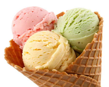A waffle cone filled with three scoops of ice cream in pink yellow and green colors close up view