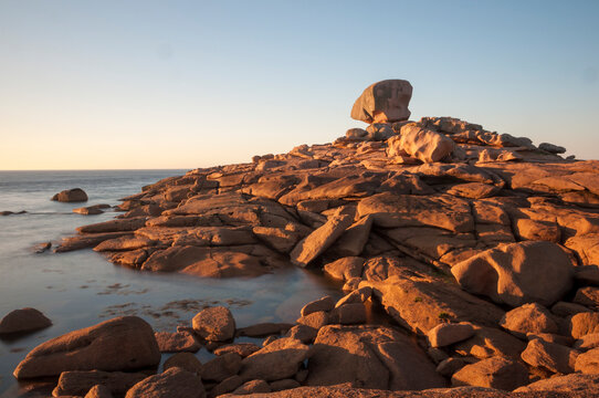 France,Bretagne.Pink granite rock formations at the coast  on a sunny summer evening