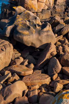 France,Bretagne.Pink granite rock formations at the coast  on a sunny summer evening