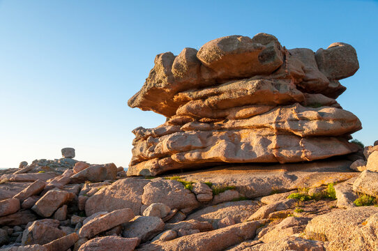 France,Bretagne.Pink granite rock formations at the coast  on a sunny summer evening