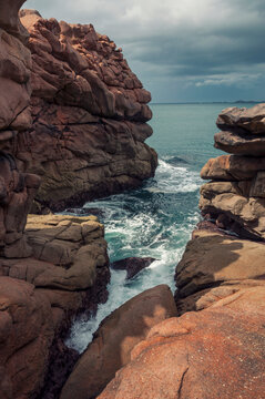 France,Bretagne.Pink granite rock formations at the coast  on a sunny summer evening
