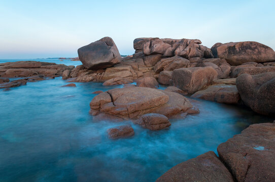 France,Bretagne.Pink granite rock formations at the coast  on a sunny summer evening