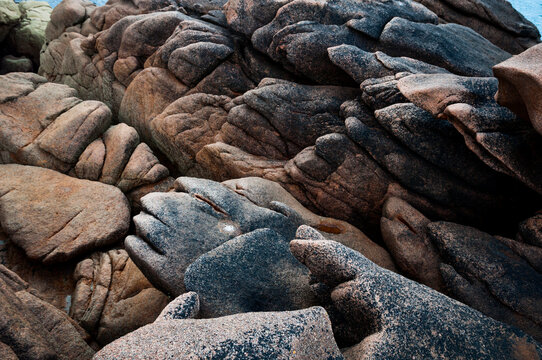 France,Bretagne.Pink granite rock formations at the coast  on a sunny summer evening