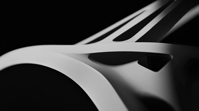 Smooth curves and chamfers of a freshly cut bicycle monocoque frame highlight precision engineering and sustainable manufacturing on a black background