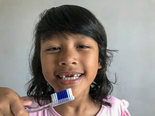 Child smiling and showing the gap from her newly lost baby tooth