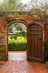 View of a beautiful arch with an old door, Filoli Historic House and Garden.
